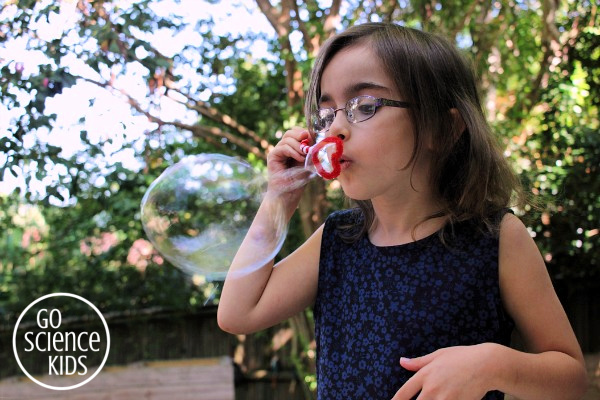 Blowing bubbles with the DIY heart bubble wand