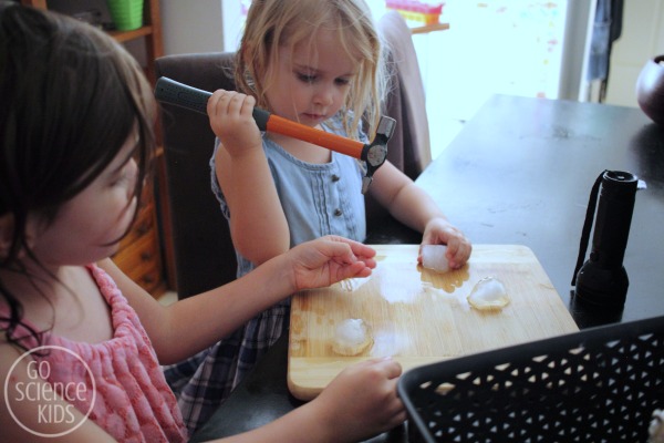 Kids breaking up tonic ice with a small hammer