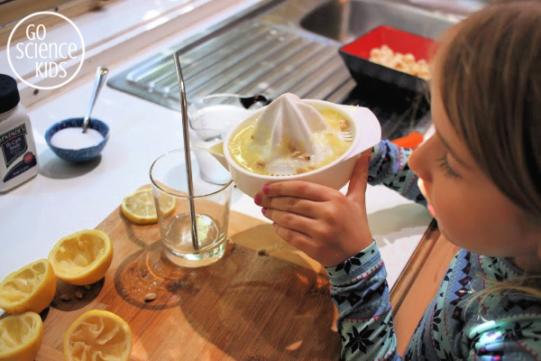 Pouring lemon juice into a glass